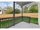 Covered back porch with gray wood, overlooking the green lawn and a wood fence at 779-B Lynwood Se St, Atlanta, GA 30312