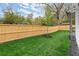 Well-maintained backyard with a green lawn, wood fence, and a newly planted tree at 779-B Lynwood Se St, Atlanta, GA 30312