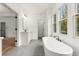 Modern bathroom features a free-standing tub, a glass-enclosed shower, and gray hexagonal tile floors at 779-B Lynwood Se St, Atlanta, GA 30312