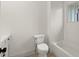 Neutral bathroom featuring a white toilet, white subway tile in the shower and bathtub area, and a small vanity at 779-B Lynwood Se St, Atlanta, GA 30312