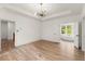Spacious bedroom features hardwood floors and an elegant chandelier, with views into a bright bathroom at 779-B Lynwood Se St, Atlanta, GA 30312