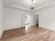 Spacious bedroom features hardwood floors and an elegant chandelier, with views into a bright bathroom at 779-B Lynwood Se St, Atlanta, GA 30312