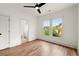 Bright bedroom with hardwood floors, a ceiling fan, and backyard views from its double window at 779-B Lynwood Se St, Atlanta, GA 30312