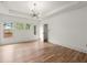 Spacious bedroom features hardwood floors, a chandelier, and large windows at 779-B Lynwood Se St, Atlanta, GA 30312