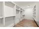 Spacious walk-in closet with custom shelving, drawers, and wood flooring provides ample storage space at 779-B Lynwood Se St, Atlanta, GA 30312