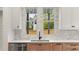Modern kitchen with stainless steel sink, marble backsplash, and wood cabinets at 779-B Lynwood Se St, Atlanta, GA 30312