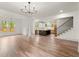 Spacious living room with hardwood floors, modern chandelier, open staircase and direct access to kitchen at 779-B Lynwood Se St, Atlanta, GA 30312