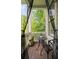 Cozy balcony featuring a small table, chairs, and a view of mature trees at 986 Mauldin Se St, Atlanta, GA 30316