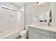 Bright bathroom with modern vanity and shower/tub combo; neutral color palette and a view to office at 986 Mauldin Se St, Atlanta, GA 30316