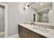 Bathroom featuring double sinks, quartz countertops and a large mirror at 986 Mauldin Se St, Atlanta, GA 30316