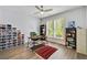 Bright office with wood floors, ceiling fan, built-in shelves, and a large window overlooking the yard at 986 Mauldin Se St, Atlanta, GA 30316