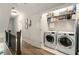 Second story laundry room with washer, dryer and storage shelving at 986 Mauldin Se St, Atlanta, GA 30316