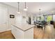 Open-concept kitchen and living area with hardwood floors, modern lighting, and a comfortable dining space at 986 Mauldin Se St, Atlanta, GA 30316