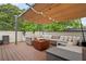Relax on the rooftop deck beneath the sunshade; featuring a fire pit and ample seating at 986 Mauldin Se St, Atlanta, GA 30316