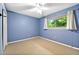 Bright bedroom featuring a ceiling fan, large window providing natural light, and neutral carpet flooring at 1111 Clairemont Ave # J6, Decatur, GA 30030