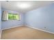 Comfortable bedroom with a large window for natural light, neutral carpet, and simple, clean design at 1111 Clairemont Ave # J6, Decatur, GA 30030