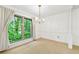 Bright dining room with large window with tree views, chandelier, and neutral walls at 1111 Clairemont Ave # J6, Decatur, GA 30030