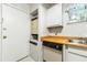 Compact kitchen space equipped with dishwasher, sink, and stackable washer/dryer, all conveniently located near an exterior door at 1111 Clairemont Ave # J6, Decatur, GA 30030