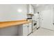 View of the kitchen showcasing white appliances, a range, and countertops, all complemented by bright lighting and tiled flooring at 1111 Clairemont Ave # J6, Decatur, GA 30030