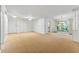 Open-concept living area with carpet, large window, and plenty of space at 1111 Clairemont Ave # J6, Decatur, GA 30030
