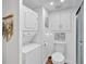 Modern bathroom features a toilet, wall-mounted decor, and an efficient stackable washer-dryer at 115 Pine Tree Dr, Fayetteville, GA 30214