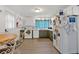 Bright kitchen features a dining area and a mix of white and green cabinetry at 115 Pine Tree Dr, Fayetteville, GA 30214