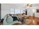 Bright living room with hardwood floors, comfortable seating, and a large window at 115 Pine Tree Dr, Fayetteville, GA 30214