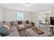 Inviting living room with sectional sofa and view into dining area and kitchen at 115 Pine Tree Dr, Fayetteville, GA 30214