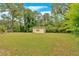 The backyard includes a small outbuilding with an over sized yard space and mature trees at 115 Pine Tree Dr, Fayetteville, GA 30214