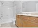 Well-lit bathroom includes tub, shower, and vanity with storage cabinets at 1150 Collier Nw Rd # 1N, Atlanta, GA 30318