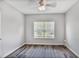 Bedroom features hard surface floors, ceiling fan and a large window at 1150 Collier Nw Rd # 1N, Atlanta, GA 30318