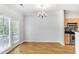 Bright dining area with hardwood floors, a chandelier, and access to a balcony at 1150 Collier Nw Rd # 1N, Atlanta, GA 30318