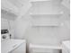Bright laundry room with white shelving units and modern washer and dryer at 1150 Collier Nw Rd # 1N, Atlanta, GA 30318