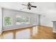 Open living area with hardwood floors, large windows, and modern ceiling fan at 1150 Collier Nw Rd # 1N, Atlanta, GA 30318
