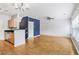 Open floor plan with hardwood floors, modern lighting, and access to a small kitchen at 1150 Collier Nw Rd # 1N, Atlanta, GA 30318