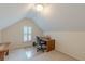 Attic office space with natural light from the window and a wood desk, perfect for a quiet workspace at 1180 Oxford Dr, Conyers, GA 30013