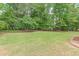 A vast, well-maintained lawn with landscaping, providing ample space for outdoor activities at 1180 Oxford Dr, Conyers, GA 30013
