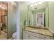 Bright bathroom features a granite countertop, a mirror, light green walls, and a walk-in shower at 1180 Oxford Dr, Conyers, GA 30013