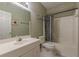 Standard bathroom with shower-tub combo, toilet, and vanity with sink under a large mirror at 1180 Oxford Dr, Conyers, GA 30013