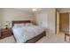 This bedroom has a ceiling fan, carpet, and access to a walk-in closet at 1180 Oxford Dr, Conyers, GA 30013