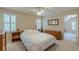 Bedroom featuring white bedding, plantation shutters, and a ceiling fan, offering a peaceful retreat at 1180 Oxford Dr, Conyers, GA 30013