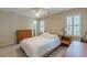 Well-lit bedroom featuring a white bed, a ceiling fan, and plantation shutters, creating a serene ambiance at 1180 Oxford Dr, Conyers, GA 30013