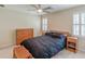 Bedroom features a queen bed, neutral walls, plantation shutters and a ceiling fan with a light at 1180 Oxford Dr, Conyers, GA 30013