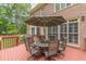 Outdoor deck features a patio table and chairs, perfect for al fresco dining and relaxing in the yard at 1180 Oxford Dr, Conyers, GA 30013