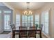 Bright dining room with shuttered windows and a chandelier above the dining table at 1180 Oxford Dr, Conyers, GA 30013