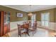 Elegant dining room with a wooden table, chandelier, and views of the outdoor shutters at 1180 Oxford Dr, Conyers, GA 30013