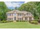 Beautiful two-story brick home with lush landscaping and a well-manicured lawn at 1180 Oxford Dr, Conyers, GA 30013