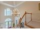 Elegant foyer with a soaring ceiling, chandelier, and view of the decorative front doors at 1180 Oxford Dr, Conyers, GA 30013