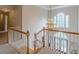 Bright foyer with a view of the front door through railings, featuring a decorative chandelier and large windows at 1180 Oxford Dr, Conyers, GA 30013
