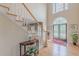 Bright foyer featuring hardwood floors, a staircase, and a decorative front entrance at 1180 Oxford Dr, Conyers, GA 30013